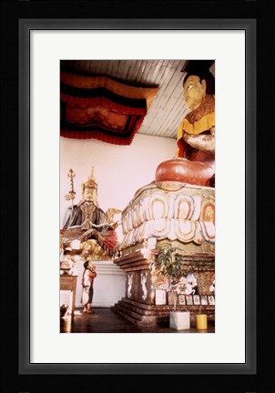 Framed Young Girl Praying in Front of a Giant Buddha Statue Print