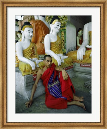 Framed Monk Sitting in Front of a Buddha Statue Print