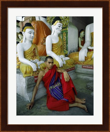 Framed Monk Sitting in Front of a Buddha Statue Print