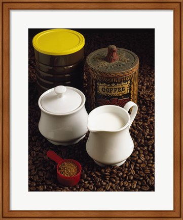 Framed Close-up of a mug of milk with a measuring spoon and jars on coffee beans Print