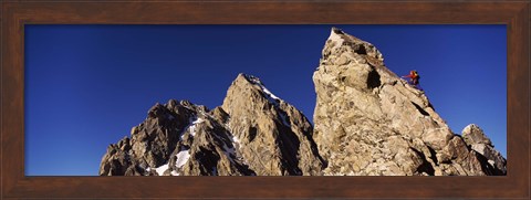 Framed Low angle view of a man climbing up a mountain, Rockchuck Peak, Grand Teton National Park, Wyoming, USA Print