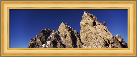 Framed Low angle view of a man climbing up a mountain, Rockchuck Peak, Grand Teton National Park, Wyoming, USA Print