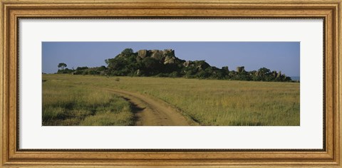 Framed Road passing through a grassland, Simba Kopjes, Road Serengeti, Tanzania, Africa Print