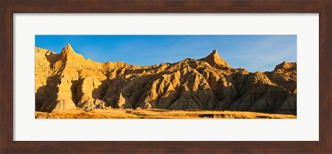 Framed Sculpted sandstone spires in golden light, Saddle Pass Trail, Badlands National Park, South Dakota, USA Print