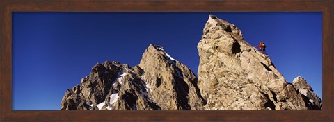 Framed Low angle view of a man climbing up a mountain, Rockchuck Peak, Grand Teton National Park, Wyoming, USA Print