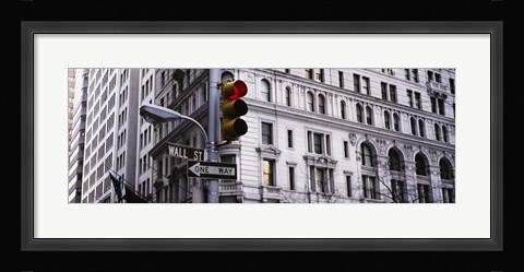 Framed Low angle view of a Red traffic light in front of a building, Wall Street, New York City Print