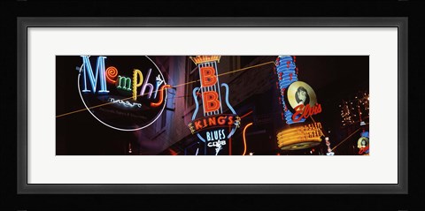 Framed Low angle view of neon signs lit up at night, Beale Street, Memphis, Tennessee, USA Print