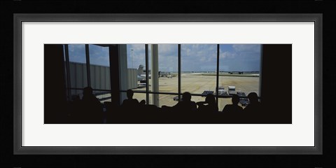 Framed Silhouette of a group of people at an airport lounge, Orlando International Airport, Orlando, Florida, USA Print