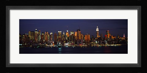 Framed Skyscrapers lit up at night in a city, Manhattan, New York City, New York State, USA Print