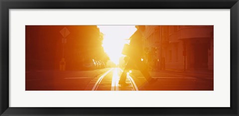 Framed Side profile of a person crossing the cable car tracks at sunset, San Francisco, California, USA Print