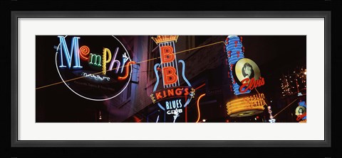 Framed Low angle view of neon signs lit up at night, Beale Street, Memphis, Tennessee, USA Print