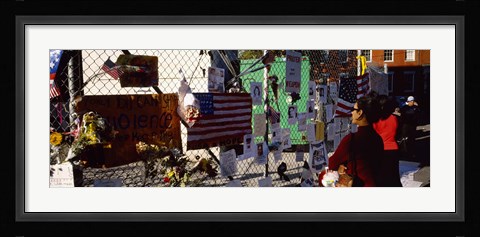 Framed Side profile of a woman standing in front of chain-link fence at a memorial, New York City, New York State, USA Print