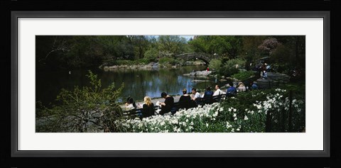 Framed Group of people sitting on benches near a pond, Central Park, Manhattan, New York City, New York State, USA Print