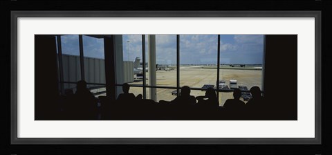 Framed Silhouette of a group of people at an airport lounge, Orlando International Airport, Orlando, Florida, USA Print