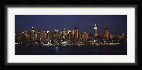 Framed Skyscrapers lit up at night in a city, Manhattan, New York City, New York State, USA Print