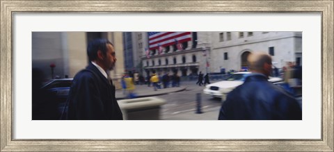 Framed Two people walking, New York Stock Exchange, Wall Street, Times Square, Manhattan, New York City, New York State, USA Print