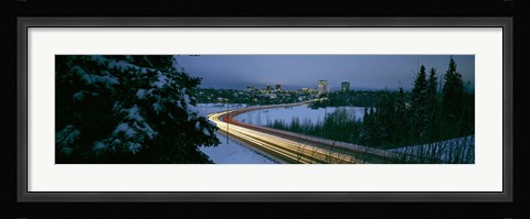 Framed Autumobile lights on busy street, distant city lights, frozen Westchester Lagoon, Anchorage, Alaska, USA. Print