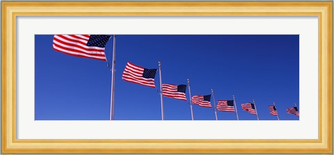 Framed Low angle view of American flags, Washington Monument, Washington DC, USA Print