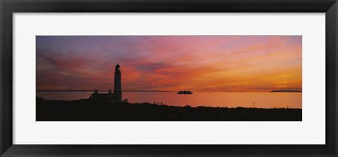 Framed Silhouette of a lighthouse at sunset, Scotland Print