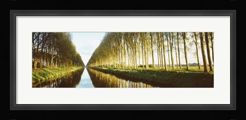 Framed Belgium, tree lined waterway through countryside Print
