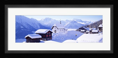 Framed Snow Covered Chapel and Chalets Swiss Alps Switzerland Print