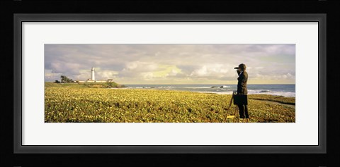 Framed USA, California, Businessman standing holding binoculars and looking at the lighthouse Print