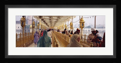 Framed Group of people walking on a bridge over a pond, Golden Temple, Amritsar, Punjab, India Print