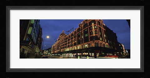 Framed Low angle view of buildings lit up at night, Harrods, London, England Print