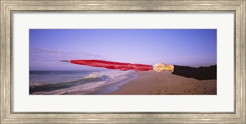 Framed Close-up of a woman&#39;s hand pointing with a red umbrella, Point Reyes National Seashore, California, USA Print