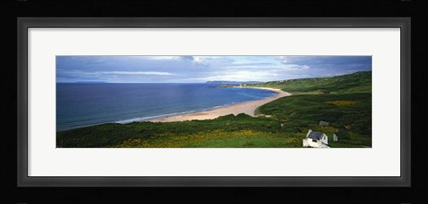 Framed Birds-eye view of sea, white stone cottage, Northern Ireland. Print