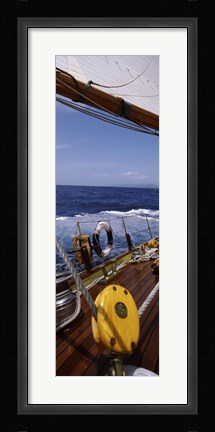 Framed Detail of the mainsheet block of a wooden sailboat in the sea Print