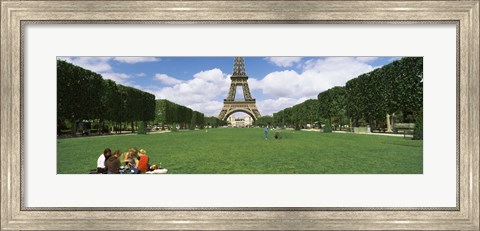 Framed Tourists sitting in a park with a tower in the background, Eiffel Tower, Paris, Ile-de-France, France Print