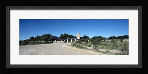 Framed Road leading towards the entrance of a rest camp, Okaukuejo, Etosha National Park, Kunene Region, Namibia Print