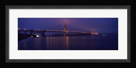 Framed Suspension bridge lit up at dawn viewed from fishing pier, Golden Gate Bridge, San Francisco Bay, San Francisco, California, USA Print