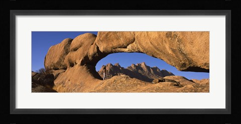 Framed Mountains viewed through a natural arch with a mother holding her baby, Spitzkoppe, Namib Desert, Namibia Print