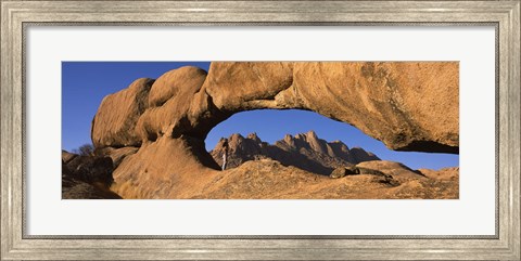 Framed Mountains viewed through a natural arch with a mother holding her baby, Spitzkoppe, Namib Desert, Namibia Print