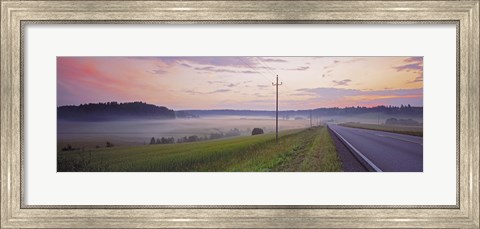 Framed Country road and telephone lines splitting farmlands at dawn, Finland Print