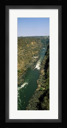 Framed Kayakers paddle down the Zambezi gorge away from the Victoria Falls, Zambia Print