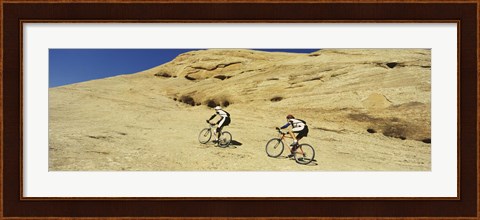 Framed Side profile of two men mountain bilking on rocks, Slickrock Trail, Moab, Utah, USA Print