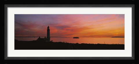 Framed Silhouette of a lighthouse at sunset, Scotland Print