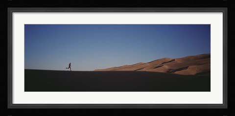 Framed USA, Colorado, Great Sand Dunes National Monument, Runner jogging in the park Print
