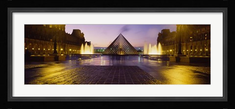 Framed Museum lit up at night with ghosted image of three men, Louvre Museum, Paris, France Print