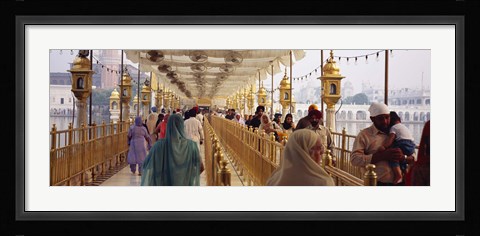 Framed Group of people walking on a bridge over a pond, Golden Temple, Amritsar, Punjab, India Print