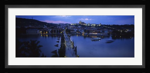 Framed High angle view of buildings lit up at dusk, Charles Bridge, Vltava River, Prague, Czech Republic Print