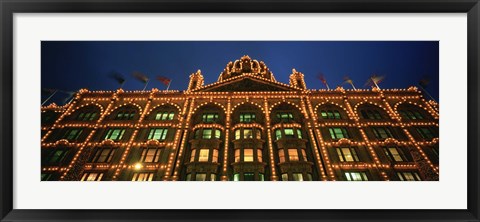 Framed Low angle view of a building lit up at night, Harrods, London, England Print