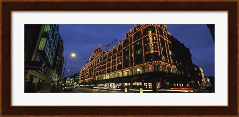 Framed Low angle view of buildings lit up at night, Harrods, London, England Print