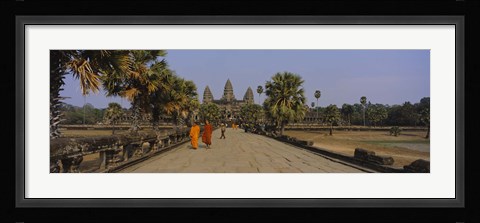 Framed Two monks walking in front of an old temple, Angkor Wat, Siem Reap, Cambodia Print
