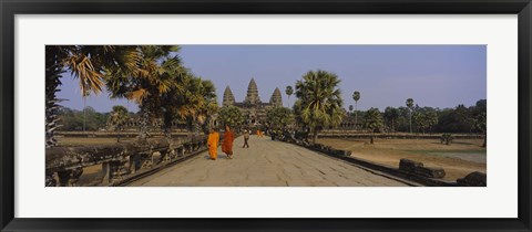 Framed Two monks walking in front of an old temple, Angkor Wat, Siem Reap, Cambodia Print