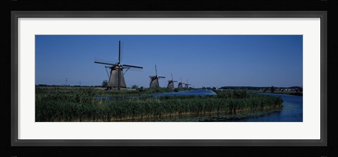 Framed Traditional windmills at a riverbank, Kinderdijk, Rotterdam, Netherlands Print