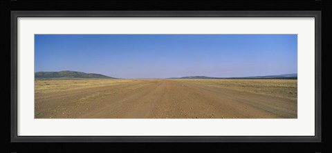 Framed Dirt road passing through a landscape, Masai Mara National Reserve, Great Rift Valley, Kenya Print